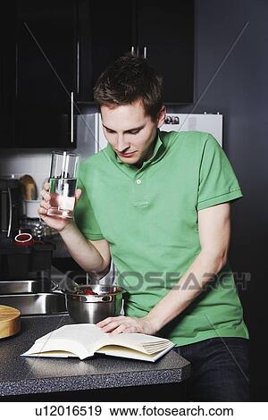 Young adult male reading View Large Photo Image Stock Photo - Young adult male reading. Fotosearch