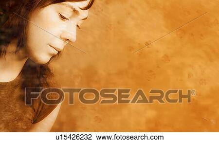 Stock Image - Young woman looking down. Fotosearch