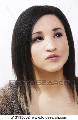 Stock Image - Young woman looking worried. Fotosearch