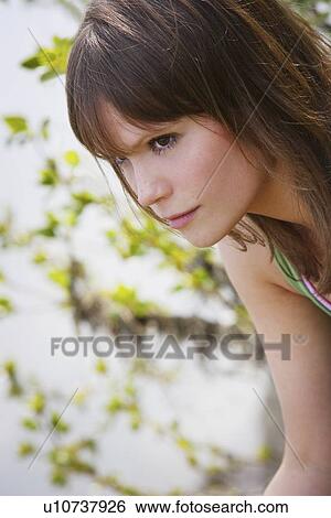 Stock Photograph - Young woman thinking. Fotosearch