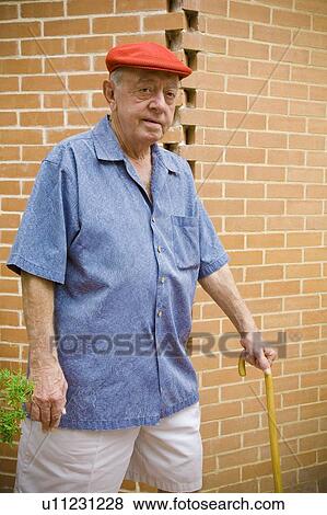 A man walking with a cane View Large Photo Image Stock Photo - A man walking with a cane. Fotosearch