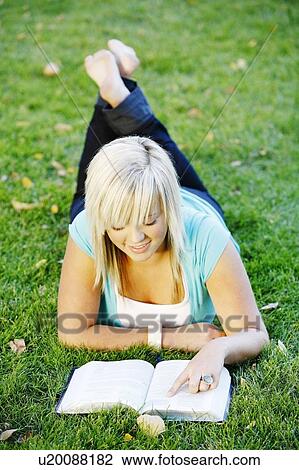 A teenage girl reading her Bible View Large Photo Image Stock Image - A teenage girl reading her Bible. Fotosearch