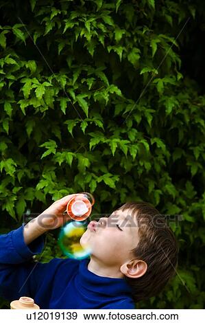 Boy blowing bubbles View Large Photo Image Stock Photo - Boy blowing bubbles. Fotosearch