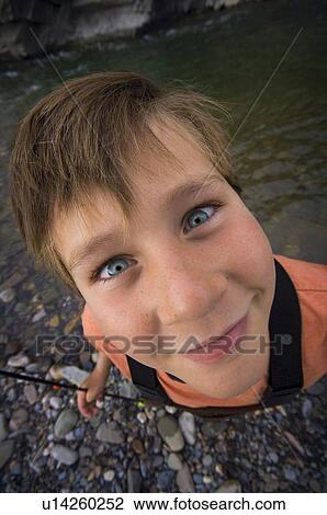 Boy fishing in river View Large Photo Image Stock Image - Boy fishing in river. Fotosearch