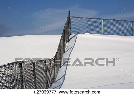 Chain link fence in the snow View Large Photo Image Stock Photo - Chain link fence in the snow. Fotosearch