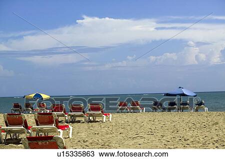 Stock Image - Chairs on a beach, Cabarete, Dominican Republic. Fotosearch
