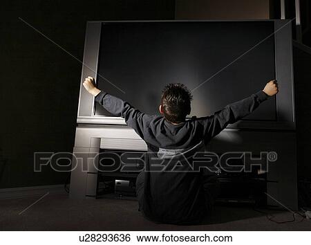 Child sitting in front of television View Large Photo Image Stock Photograph - Child sitting in front of television. Fotosearch