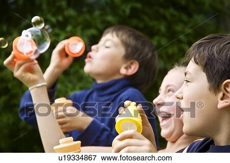 Children blowing bubbles View Large Photo Image Stock Photo - Children blowing bubbles. Fotosearch