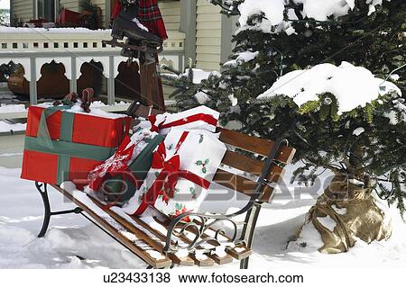 Stock Photo - Christmas gifts on a park bench. Fotosearch