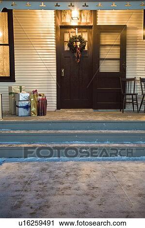 Stock Image - Christmas gifts on porch. Fotosearch