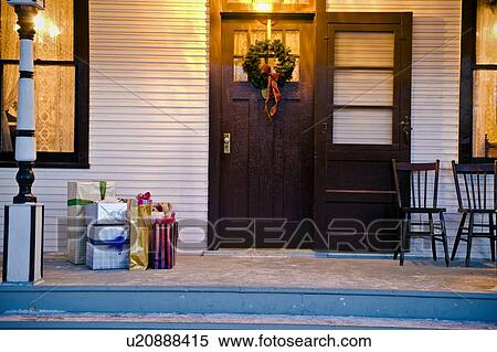 Stock Photography - Christmas gifts outside the front door. Fotosearch