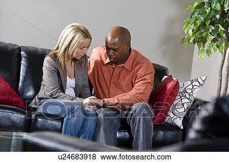Stock Photo - Couple praying together. Fotosearch