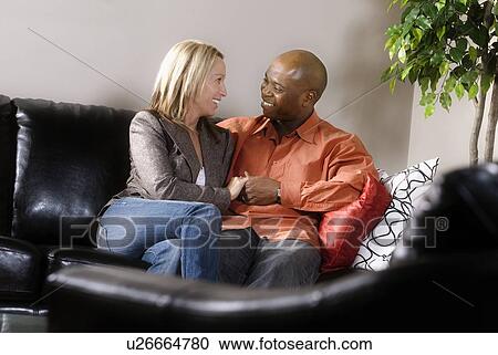Couple sitting close together View Large Photo Image Stock Image - Couple sitting close together. Fotosearch