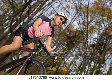 Stock Photography - Cyclist on recreational trail in the autumn . Fotosearch