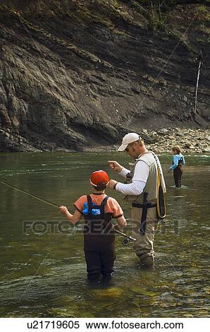 Father and sons fly fishing in mountain river View Large Photo Image Stock Photography - Father and sons fly fishing in mountain river . Fotosearch