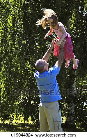 Father being playful with daughter View Large Photo Image Picture - Father being playful with daughter. Fotosearch