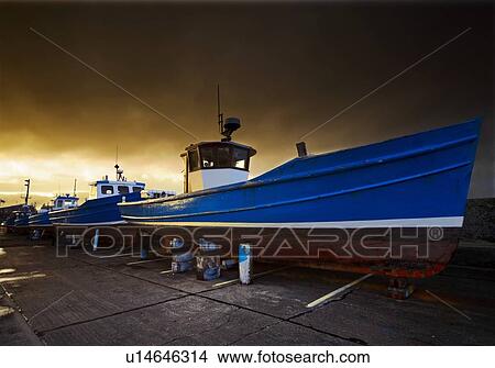 Fishing boats out of the water for winter, Seahouses, Northumberland, England View Large Photo Image Picture - Fishing boats out of the water for winter, Seahouses, Northumberland, England. Fotosearch