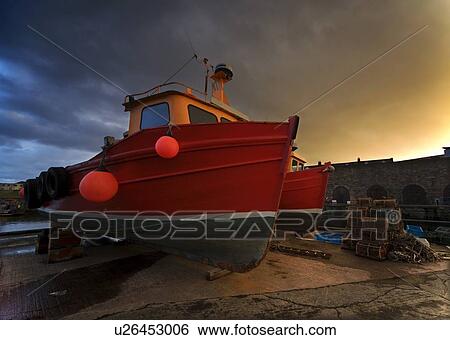 Stock Photograph - Fishing boats out of the water for winter . Fotosearch