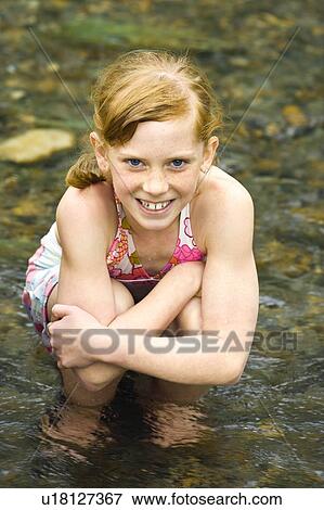 Stock Photo - Girl sitting in water. Fotosearch