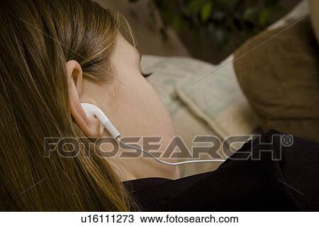 Stock Image - Girl with ear buds. Fotosearch