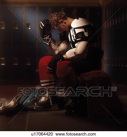 Stock Image - Hockey player in dressing room. Fotosearch