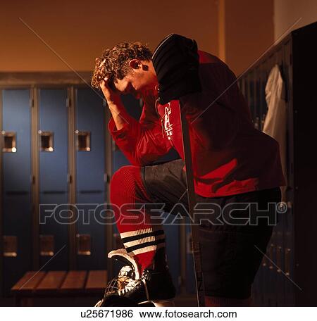 Stock Photograph - Hockey player in dressing room. Fotosearch