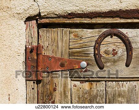 Horse shoe on old wooden door View Large Photo Image Picture - Horse shoe on old wooden door. Fotosearch