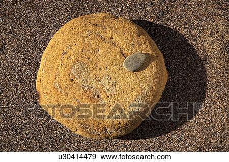Large and small stone on sand View Large Photo Image Stock Photo - Large and small stone on sand. Fotosearch