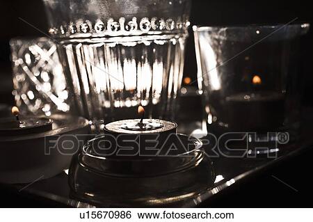 Lit candles and glassware View Large Photo Image Stock Photograph - Lit candles and glassware. Fotosearch