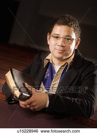 Man holding a Bible View Large Photo Image Stock Photograph - Man holding a Bible. Fotosearch