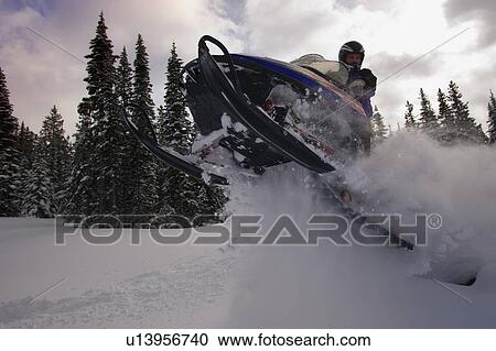 Man jumping a snowmobile View Large Photo Image Stock Image - Man jumping a snowmobile. Fotosearch