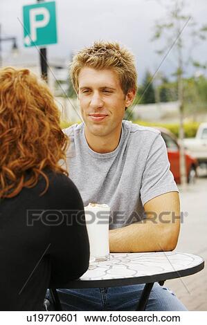 Man looking at woman at outdoor cafe View Large Photo Image Stock Image - Man looking at woman at outdoor cafe. Fotosearch