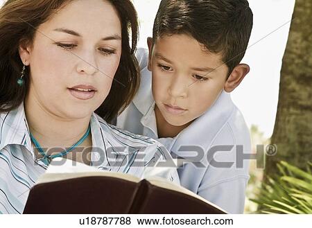 Mother and son reading a Bible View Large Photo Image Stock Photo - Mother and son reading a Bible. Fotosearch