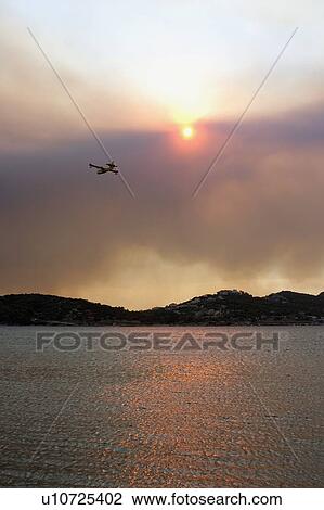 Stock Image - Plane flying over Anavissos, Greece. Fotosearch