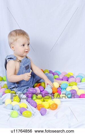 Portrait of a baby surrounded by plastic Easter eggs View Large Photo Image Stock Photograph - Portrait of a baby surrounded by plastic Easter eggs. Fotosearch