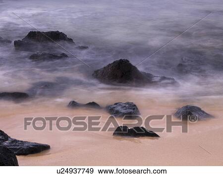 Rocks in the water and on the beach, Poipu, Kauai, Hawaii View Large Photo Image Stock Photo - Rocks in the water and on the beach, Poipu, Kauai, Hawaii. Fotosearch