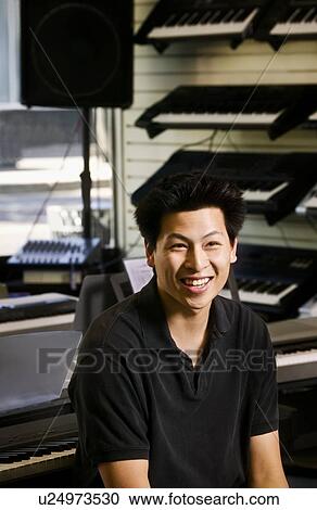 Salesman in a music store View Large Photo Image Stock Image - Salesman in a music store. Fotosearch