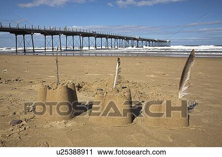 Stock Image - Sand castles by the pier, Saltburn, North Yorkshire, UK. Fotosearch