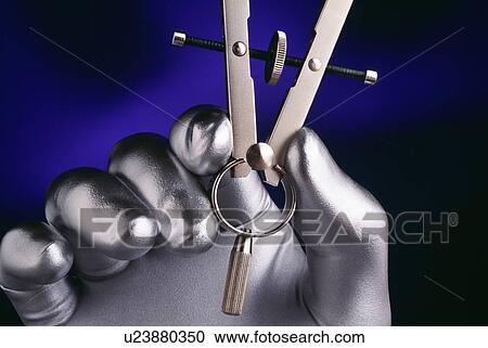 Silver hand holding drafting compass View Large Photo Image Stock Image - Silver hand holding drafting compass. Fotosearch