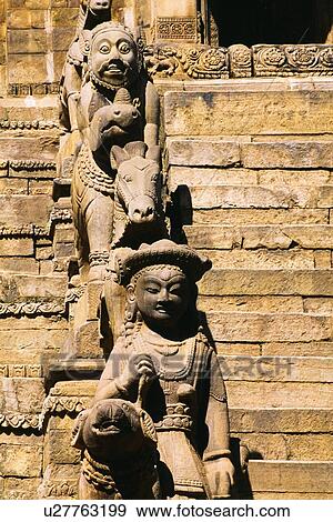 Stock Photo - Statues beside stairs, Siddhi Lakshmi Temple, Bhaktapur, Nepal. Fotosearch