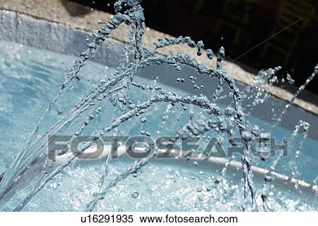 Stock Photography - Streams of water from a fountain. Fotosearch