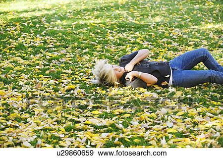 Teenage girl rolling down a hill View Large Photo Image Stock Photo - Teenage girl rolling down a hill. Fotosearch