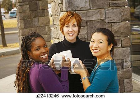 Stock Photograph - Three women celebrating together. Fotosearch