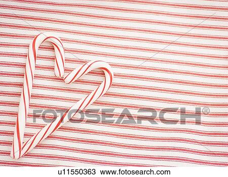 Stock Image - Two candy canes making a heart shape. Fotosearch