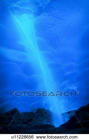 Stock Photograph - Waterfall in ice cave. Fotosearch