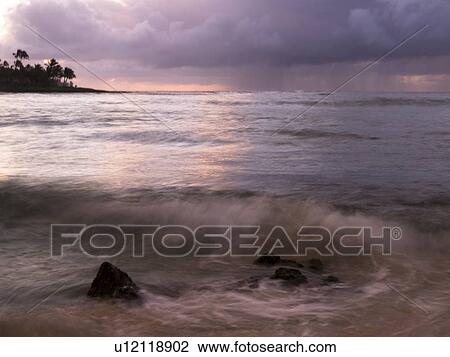 Stock Image - Waves and storm clouds, Poipu, Kauai, Hawaii. Fotosearch