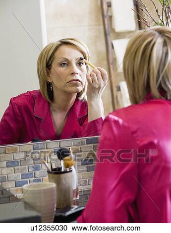 Woman applying makeup View Large Photo Image Stock Image - Woman applying makeup. Fotosearch
