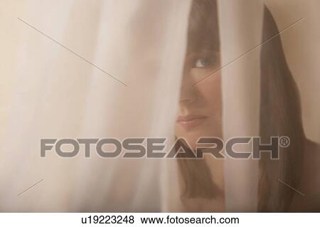 Stock Photo - Woman behind a veil. Fotosearch