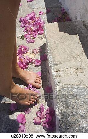 Stock Photo - Woman standing on pink flowers, Hydra Island, Saronic, Greece. Fotosearch