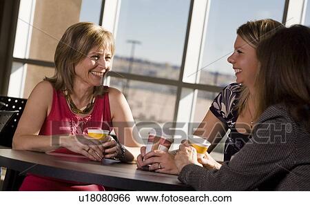 Women visiting together View Large Photo Image Stock Photograph - Women visiting together. Fotosearch